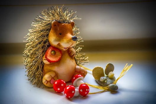 Handmade ceramic hedgehog for the background.