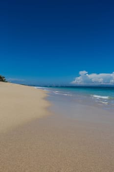 Beautiful secluded sandy beach in the Caribbean with white sand and blue sky as in paradise