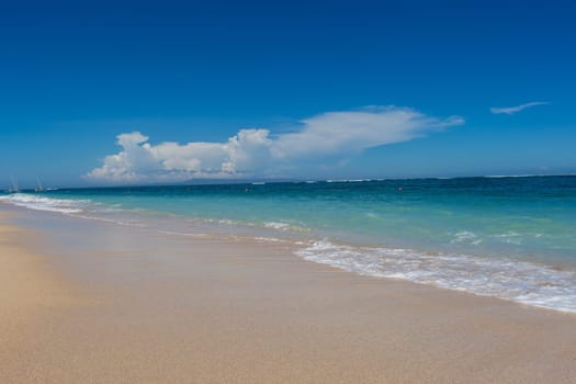 Beautiful secluded sandy beach in the Caribbean with white sand and blue sky as in paradise