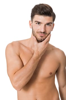 attractive muscular young man with free torso and beard isolated against white background