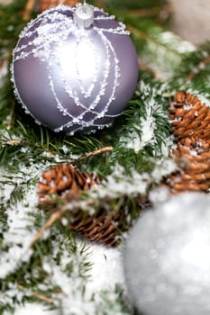 Silver Christmas bauble jewelry with deer and fir branches decoration for Christmas as macro detail