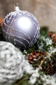 Silver Christmas bauble jewelry with deer and fir branches decoration for Christmas as macro detail