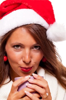 Attractive young woman with red Santa hat drinks a hot cup of coffee she weighs in her hands to warm her hands Insulated freeagent