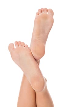 Woman with neatly groomed natural nails without varnish shows off her feet in a beauty concept on a white background