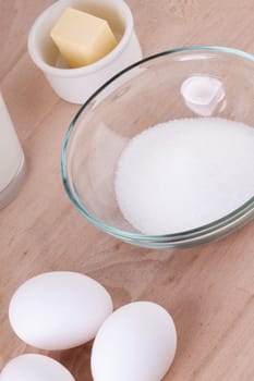 Baking ingredients in the kitchen me eggs,flour,butter and sugar to stir a dough and bake a cake