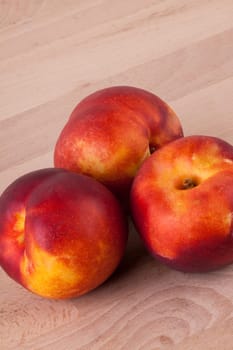 Fresh nectarines,oranges,peaches close-up on white background