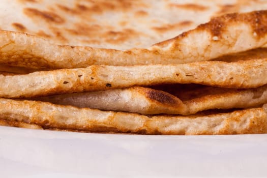 delicious fresh crepes pancakes pancakes on a white plate on a rustic white wooden board