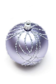 Glittering silver Christmas bauble on white background Macro detail