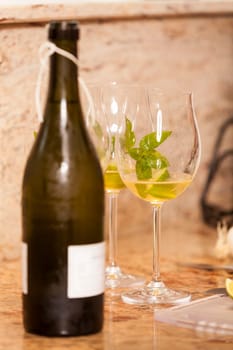 Sparkling wine bottle with wine glasses for an aperitif in a kitchen