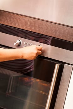 Oven steam cooker with one hand when operating as close-up