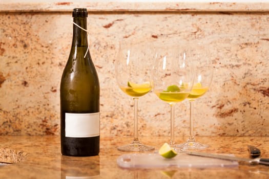 Sparkling wine bottle with wine glasses for an aperitif in a kitchen