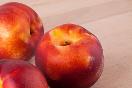 Fresh nectarines,oranges,peaches close-up on white background