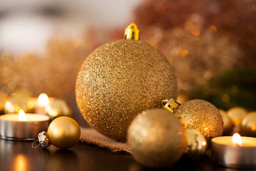 Warm golden and orange Christmas decoration with candlelight as close-up in context