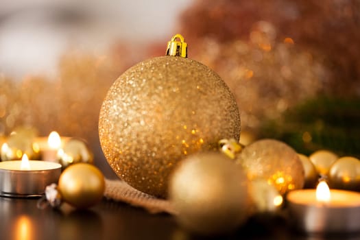 Warm golden and orange Christmas decoration with candlelight as close-up in context