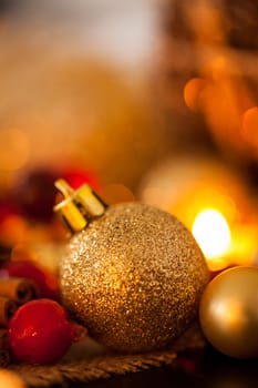 Warm golden and orange Christmas decoration with candlelight as close-up in context