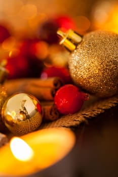 Warm golden and orange Christmas decoration with candlelight as close-up in context