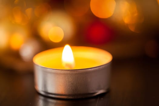 Warm golden and orange Christmas decoration with candlelight as close-up in context