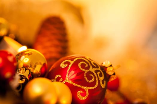 Warm golden and orange Christmas decoration with candlelight as close-up in context