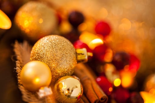 Warm golden and orange Christmas decoration with candlelight as close-up in context