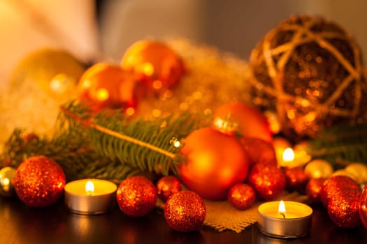 Warm golden and orange Christmas decoration with candlelight as close-up in context