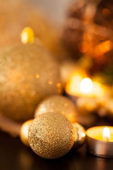 Warm golden and orange Christmas decoration with candlelight as close-up in context