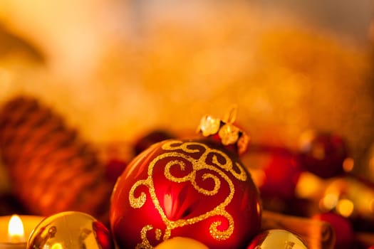 Warm golden and orange Christmas decoration with candlelight as close-up in context
