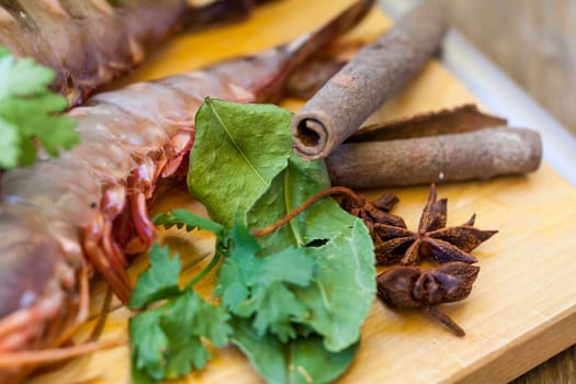 Ingredients for Tom Yam soup with lemongrass shrimp coriander on a kitchen board