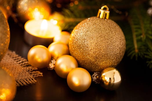 Warm golden and orange Christmas decoration with candlelight as close-up in context