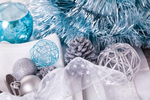 Stylish table with Christmas decoration in turquoise and silver shiny with cutlery