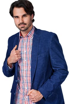 Young man in trendy casual look with dark hair and beard isolated against a white background