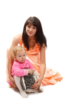 A blond little daughter with her brunette mom