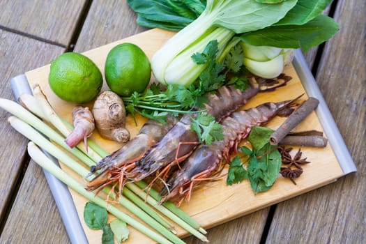 Ingredients for Tom Yam soup with lemongrass shrimp coriander on a kitchen board