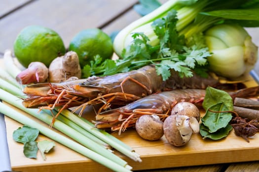 Ingredients for Tom Yam soup with lemongrass shrimp coriander on a kitchen board