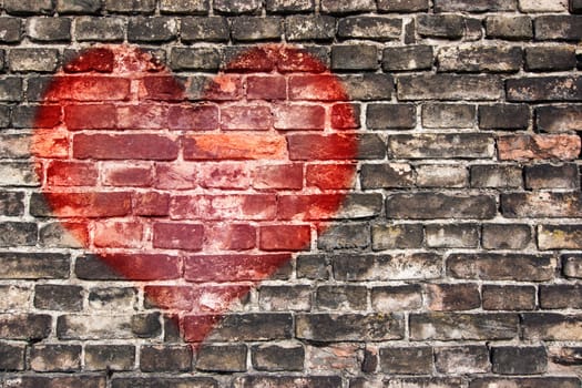 Image of the heart on the old broken brick wall