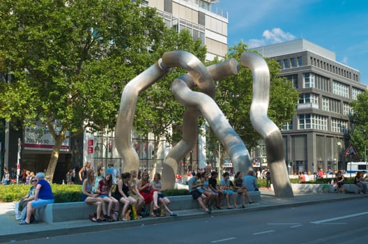 people around a modern sculpture in berlin, germany. The monument was installed in 1987 by Brigitte Matschinsky-Denning hoff and Martin Matschinsky