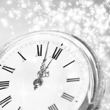 New Year's at midnight - Old clock with stars snowflakes and holiday lights