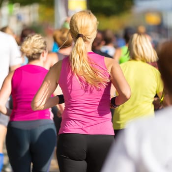 Group of active people running in the city. Healthy lifestyle. Weight Loss. Urban marathon run.