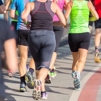 Group of active people running in the city. Healthy lifestyle. Weight Loss. Urban marathon run.