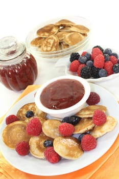 baked poffertjes with raspberries and blueberries