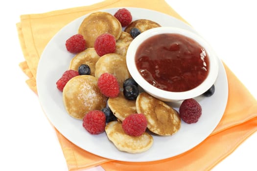 baked poffertjes with raspberries and blueberries