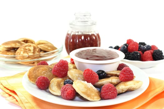 baked poffertjes with raspberries and blueberries