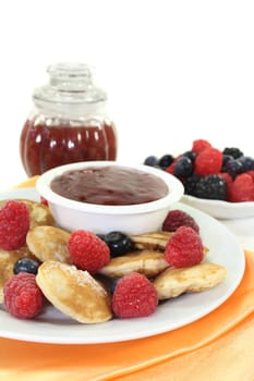 baked poffertjes with raspberries and blueberries