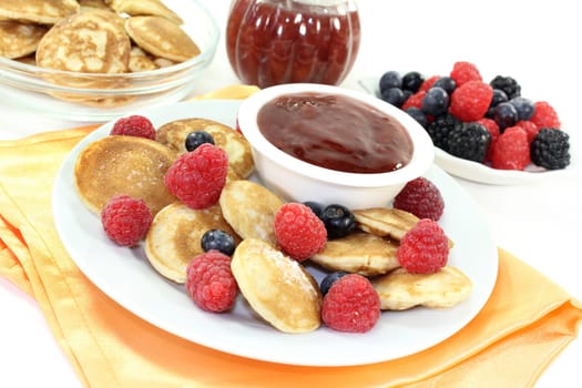 baked poffertjes with raspberries and blueberries