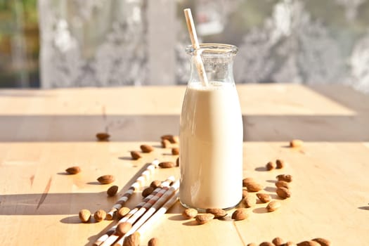 Almond milk in vintage milk bottle with drinking straws