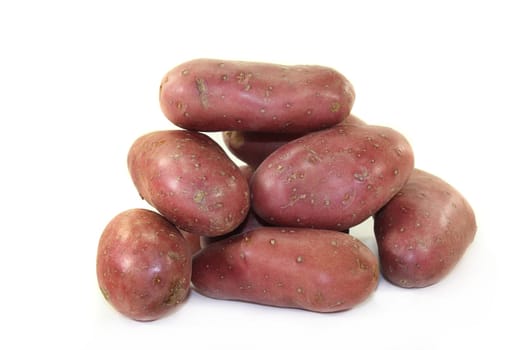 raw,red potatoes against a white background