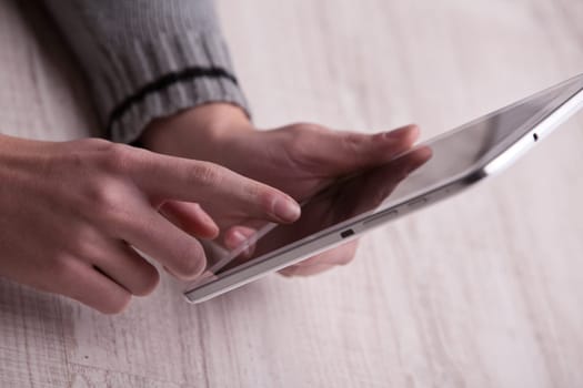 a hand of a young man touching a tablet