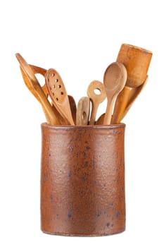 Old clay pot with wooden kitchen utensils isolated on white Background