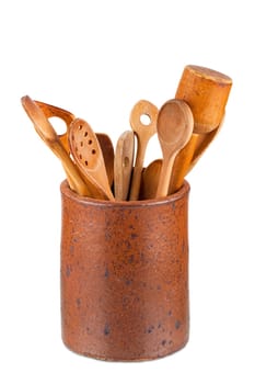 Old clay pot with wooden kitchen utensils isolated on white Background