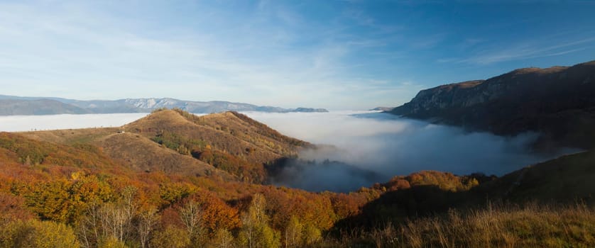Panoramic view of foggy autumn morning in the mountains