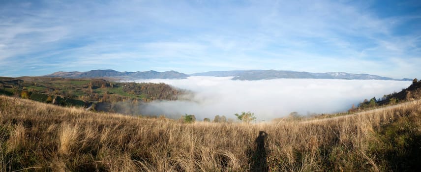 Panoramic view of foggy autumn morning in the mountains